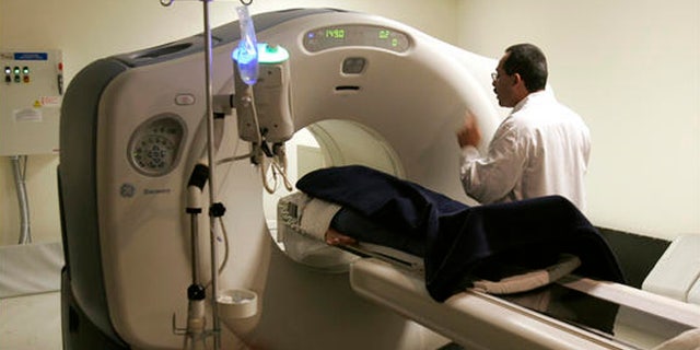 A patient is put through a cat scan machine in Kingston, N.Y.