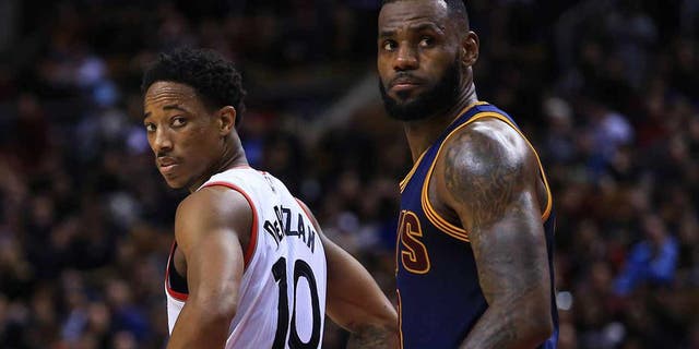 TORONTO, ON - DECEMBER 05: Lebron James #23 of the Cleveland Cavaliers and DeMar DeRozan #10 of the Toronto Raptors look on during the second half of an NBA game at Air Canada Centre on December 5, 2016 in Toronto, Canada. NOTE TO USER: User expressly acknowledges and agrees that, by downloading and or using this photograph, User is consenting to the terms and conditions of the Getty Images License Agreement. (Photo by Vaughn Ridley/Getty Images)