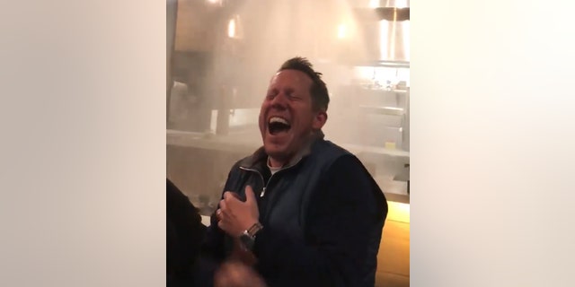 The large group of diners couldn't stop laughing after watching the sprinklers soak down the waitstaff.