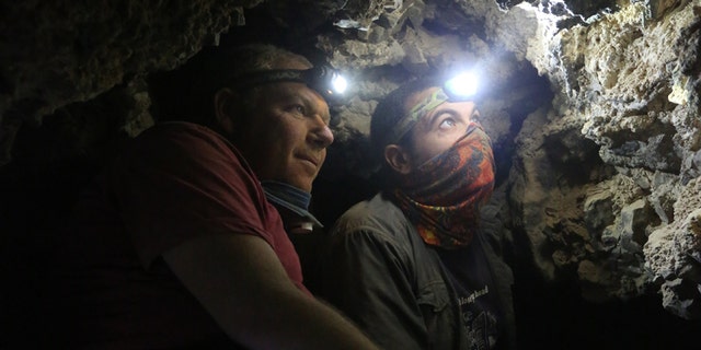 Archaeologists Oren Gutfeld & Ahiad Ovadia survey the cave.