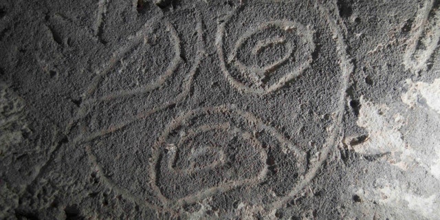 Indigenous rock art from Mona island. "Finger-fluted" design scratched by the artist into the soft walls of the cave (Project El Corazon del Caribe).