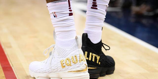 LeBron James made a statement during an NBA game with his shoes — one black, one white, with the word "equality" in capital gold letters on the back of each.