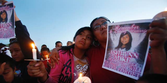 May 4, 2016: Klandre Willie, left, and her mother, Jaycelyn Blackie, participate in a candlelight vigil for Ashlynne Mike at the San Juan Chapter House in Lower Fruitland, N.M. The FBI said Ashlynne was abducted after school and her body was found the next day. The death of the young Navajo Nation girl is fueling efforts to create an Amber Alert plan on the vast reservation.