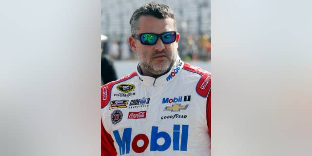 In this photo taken Friday July 15, 2016 Tony Stewart is seen before qualifying at New Hampshire Motor Speedway for Sunday's New Hampshire 301 auto race in Loudon, N.H. Stewart finished Sunday's race second and strengthened his spot inside the top 30 in the points standings.  (AP Photo/Jim Cole)
