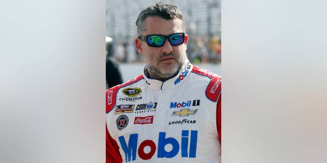 In this photo taken Friday July 15, 2016 Tony Stewart is seen before qualifying at New Hampshire Motor Speedway for Sunday's New Hampshire 301 auto race in Loudon, N.H. Stewart finished Sunday's race second and strengthened his spot inside the top 30 in the points standings. (AP Photo/Jim Cole)