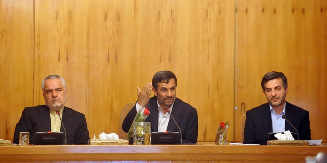 In this Sunday, May 1, 2011 file photo, Iranian President Mahmoud Ahmadinejad, center, speaks, as his office director, Esfandiar Rahim Mashaei, right, and Vice-President Mohammad Reza Rahimi, listen, in a cabinet meeting, in Tehran, Iran. (AP/IIPA/File)