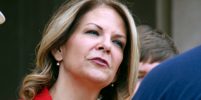 FILE: Kelli Ward speaks to the media as she prepares to file her nominating petitions at the state Capitol in Phoenix
