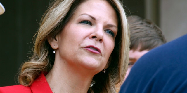 FILE: Kelli Ward speaks to the media as she prepares to file her nominating petitions at the state Capitol in Phoenix
