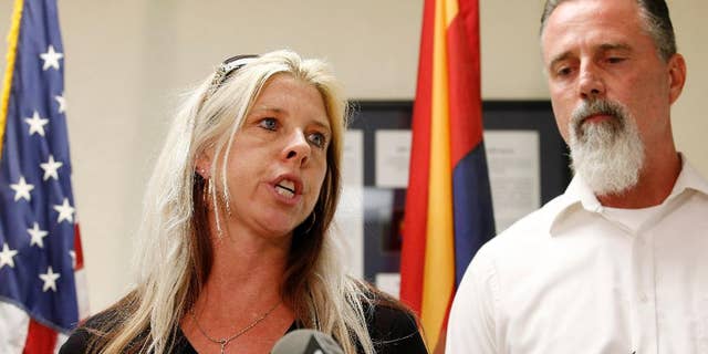 Family members of the victims, Jeanne Brown, left, who had a sister and father murdered, speaks during a news conference as her husband Richard Brown listens, after the nearly two hour long execution of Joseph Rudolph Wood at the state prison on Wednesday, July 23, 2014, in Florence, Ariz. (AP Photo)