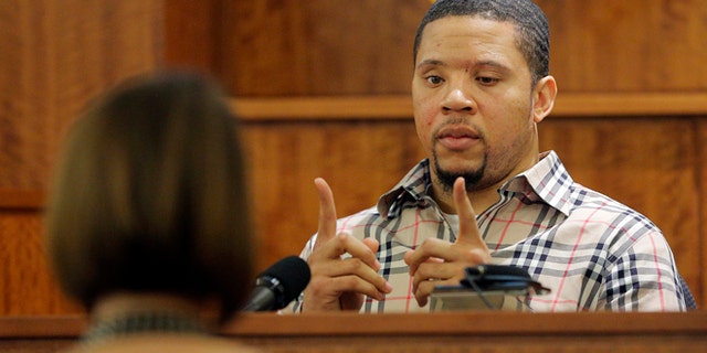 Prosecution witness Alexander Bradley describes a gun he saw with former New England Patriots NFL football player Aaron Hernandez on a trip to Florida as Bradley testifies during Hernandez's murder trial, Wednesday, April 1, 2015, at Bristol County Superior Court in Fall River, Mass. Hernandez is accused of killing Odin Lloyd in June 2013. (AP Photo/Brian Snyder, Pool)