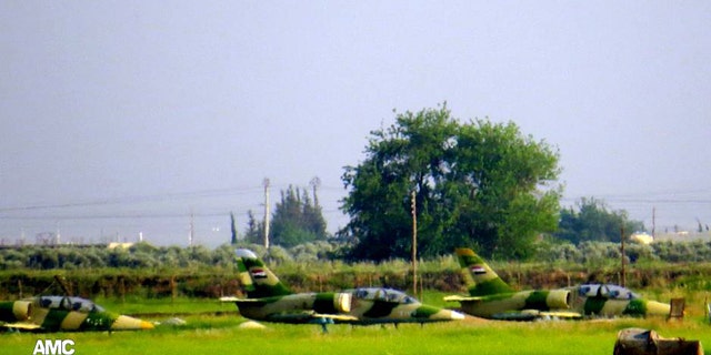 This citizen journalism image provided by Aleppo Media Center AMC which has been authenticated based on its contents and other AP reporting, shows planes on the ground at the Kweiras military air base in Aleppo province, Syria, Sunday, May. 5, 2013. Syrian Observatory for Human Rights said rebels moved deep inside Mannagh air base, near the border with Turkey, while under fire from government warplanes. (AP Photo/Aleppo Media Center AMC)