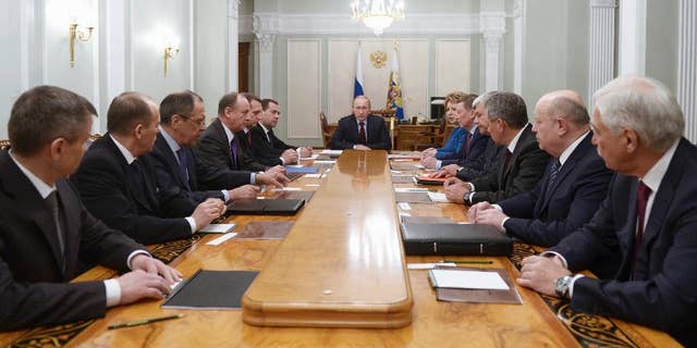 Russian President Vladimir Putin, center, chairs a Security Council meeting in the Novo-Ogaryovo residence outside Moscow, Russia, Friday, Jan. 30, 2015. (AP Photo/RIA-Novosti, Alexei Nikolsky, Presidential Press Service)