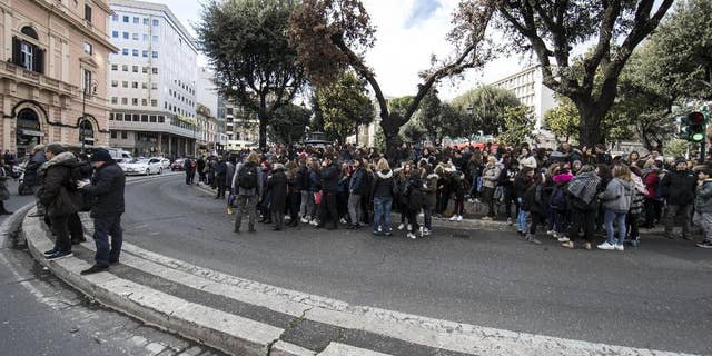 Students and teachers stand outside a highschool after it was evacuated following three earthquakes which hit central Italy in the space of an hour, shaking the same region that suffered a series of deadly quakes last year, in Rome, Wednesday, Jan. 18, 2017. (Massimo Percossi/ANSA via AP)