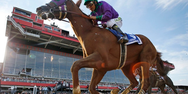 May 17, 2014: California Chrome, ridden by jockey Victor Espinoza, wins the 139th Preakness Stakes horse race at Pimlico Race Course in Baltimore.