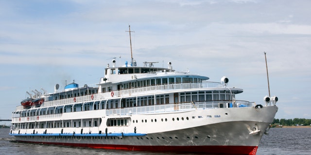 The white steamship floats on the river