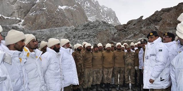April 8, 2012: In this photo released by Inter Services Public Relations, Pakistan's army chief Gen. Ashfaq Parvez Kayani, second right, talks to soldiers during his visit to avalanche incident site in Siachen, in northern Pakistan.
