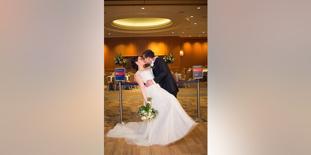 The pair chose navy and red as their wedding colors, in a salute to the carrier.