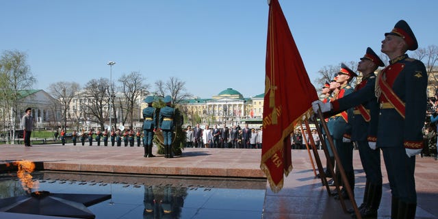 Russian President Vladimir Putin, in the background, takes part in a wreath laying ceremony at the Tomb of Unknown Soldier on the eve of the Victory Day in Moscow, Wednesday, May 8, 2013. President Vladimir Putin attended a ceremony ahead of two days of public holiday and military parades for Victory Day, which remains a significant event on the Russian calendar. (AP Photo/RIA-Novosti, Yekaterina Shtukina, Government Press Service)