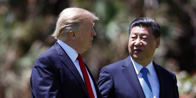 FILE - In this April 7, 2017 file photo, President Donald Trump, left, and Chinese President Xi Jinping walk together after their meetings at Mar-a-Lago, in Palm Beach, Fla. Trump has praised Xi since hosting him at his Palm Beach, Fla., resort, after sharply criticizing China’s economic policies as a candidate. Since taking office, Trump has displayed a striking willingness to embrace autocrats as potential partners in his “America First” agenda, even if it means ignoring their heavy-handed tactics and repression at home. (AP Photo/Alex Brandon, File)