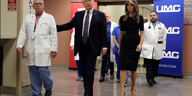 President Donald Trump and first lady Melania Trump walk with surgeon Dr. John Fildes at the University Medical Center after meeting with victims of the mass shooting Wednesday, Oct. 4, 2017, in Las Vegas.