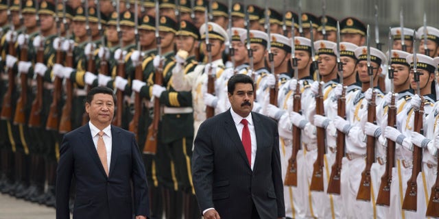 Presidents Xi Jinping and Nicolas Maduro during a ceremony outside the Great Hall of the People in Beijing, China, Sept. 22, 2013.