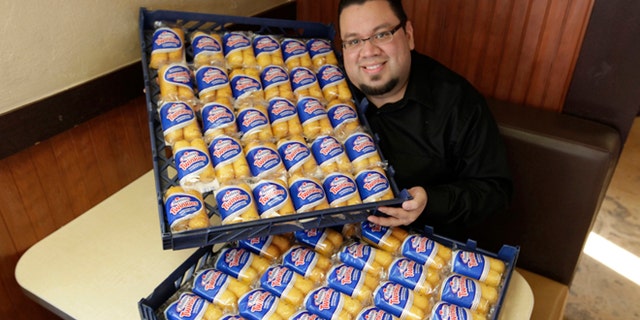 Dec. 5, 2012: Andres DeLeon of Baby's Steak & Lemonade in Orland Park, Ill, poses with a large supply of Hostess Twinkies at his restaurant.