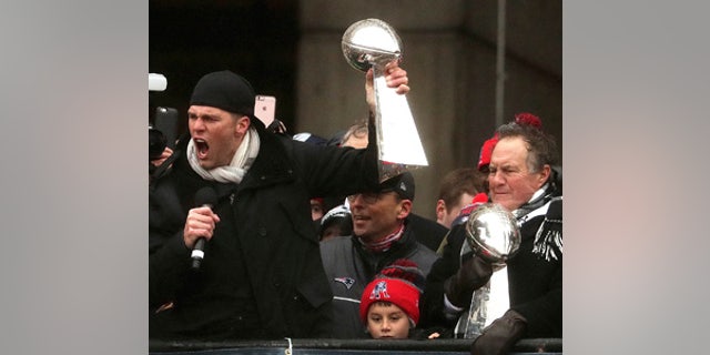 New England Patriots quarterback Tom Brady and head coach Bill Belichick hold Super Bowl trophies during a rally Tuesday, Feb. 7, 2017, in Boston to celebrate Sunday's 34-28 win over the Atlanta Falcons in the NFL Super Bowl 51 football game in Houston.  (Barry Chin /The Boston Globe via AP, Pool)