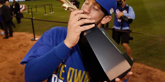 Kansas City Royals' James Shields kisses the trophy after the Royals defeated the Baltimore Orioles to win the American League baseball championship series Wednesday, Oct. 15, 2014, in Kansas City, Mo. The Royals advance to the World Series. (AP Photo/Matt Slocum )