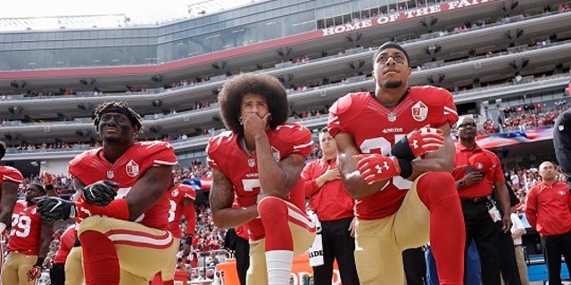 Colin Kaepernick, center, knelt during the playing of the national anthem prior to every game during the 2016 NFL season.