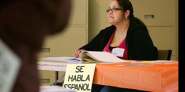 A sign reading, "Se habla Espanol", identifies a bilingual election official as voters go to the polls for Super Tuesday primaries in the predominantly Latino neighborhood of Boyle Heights on February 5, 2008 in Los Angeles, California.