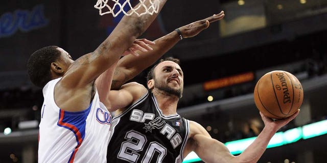 Manu Ginobili #20 of the San Antonio Spurs attempts a shot over the defense of DeAndre Jordan #9 of the Los Angeles Clippers during a 90-85 Clipper win at the Staples Center on December 1, 2010 in Los Angeles, California.