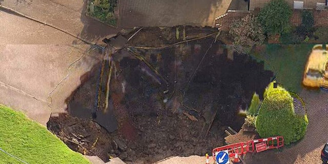 A sinkhole in St Albans, UK, has cut off more than 50 homes.