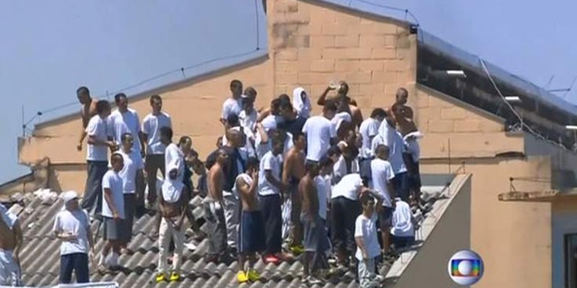 Inmates at the Parana state prison in southern Brazil demand better food and improved living conditions during a riot.