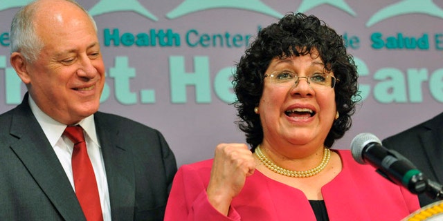 Celeste Castillo at a news conference in Chicago as Gov. Pat Quinn looks on.