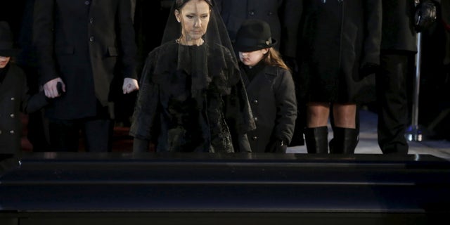 January 22, 2016. Singer Celine Dion walks up to the casket of her husband Rene Angelil following his funeral at Notre Dame Basilica in Montreal.