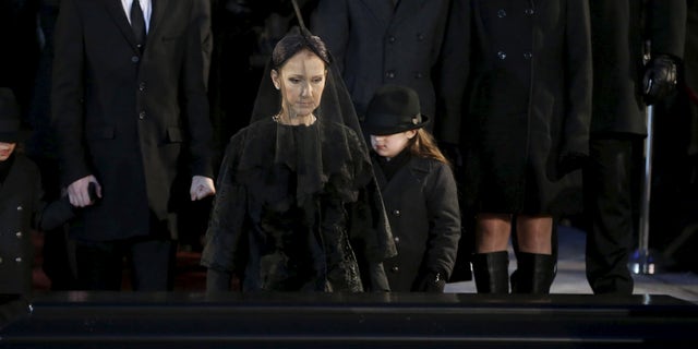 January 22, 2016. Singer Celine Dion walks up to the casket of her husband Rene Angelil following his funeral at Notre Dame Basilica in Montreal.
