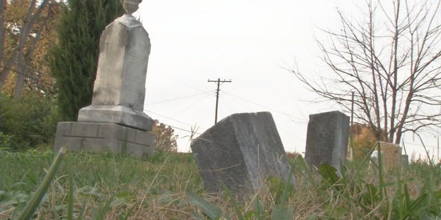 A plan to rebury 17 unidentified bodies discovered through a road project has families now threatening a lawsuit.