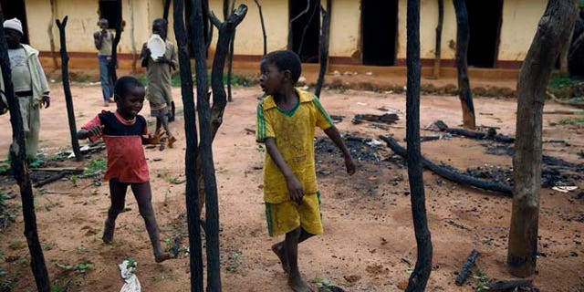 In this April 15 2014 picture, children walk through the burned Muslim district in the Western Central African town of Guen, Central African Republic. (AP)
