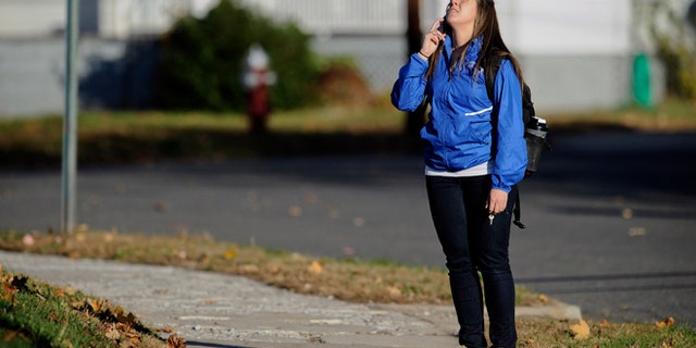 Nov. 4, 2013: A student waits to return to campus following a lockdown due to a sighting of an armed man at Central Connecticut State University in New Britain, Conn.