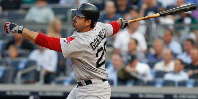 Boston Red Sox's Adrian Gonzalez follows through on an RBI triple during the first inning of a baseball game ,Tuesday, June 7, 2011, at Yankee Stadium in New York. (AP Photo/Frank Franklin II)