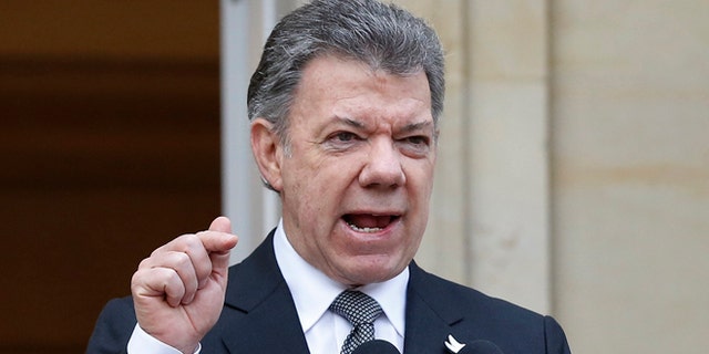 Colombia's President Juan Manuel Santos speaks to the media after a welcoming ceremony for South Korea's President Park Geun-hye at the presidential palace in Bogotá, Colombia, Friday, April 17, 2015. In a sharply worded rebuke, Santos said Colombians' patience is wearing thin after guerrillas this week attacked an army platoon sleeping in the field and killed 11 soldiers.  (AP Photo/Fernando Vergara)