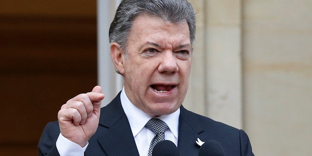 Colombia's President Juan Manuel Santos speaks to the media after a welcoming ceremony for South Korea's President Park Geun-hye at the presidential palace in Bogotá, Colombia, Friday, April 17, 2015. In a sharply worded rebuke, Santos said Colombians' patience is wearing thin after guerrillas this week attacked an army platoon sleeping in the field and killed 11 soldiers. (AP Photo/Fernando Vergara)