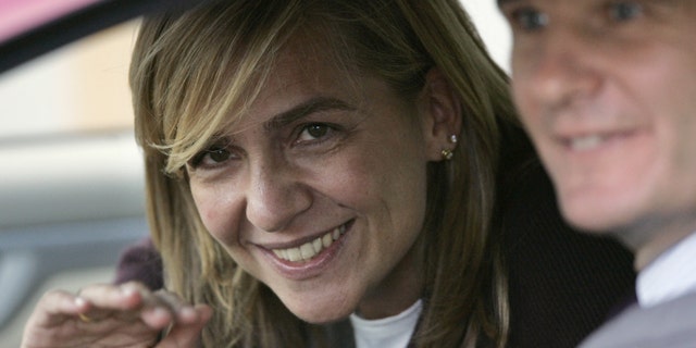 FILE- Spain's Princess Cristina waves from inside a car beside her husband Inaki Urdangarin, in Madrid, Spain, in this file photo dated Wednesday Nov. 2, 2005. A Spanish court has named the king's daughter Princess Cristina Wednesday April 3, 2013, as a suspect in an alleged corruption case involving her husband, and the court has announced that it will call her for questioning. The Spanish royal palace refused to comment. (AP Photo/Daniel Ochoa de Olza, File)