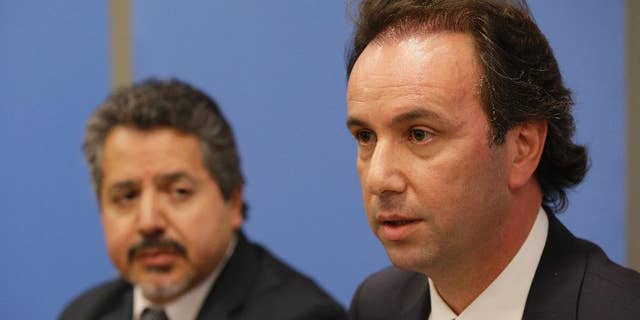 President of the Syrian National Coalition Khaled Khoja, right, is joined by Syrian National Coalition Special Representative to the U.S. and the United Nations Najib Ghadbian as he speaks to reporters during a news conference, Wednesday, Sept. 30, 2015 at U.N. headquarters. (AP Photo/Mary Altaffer)