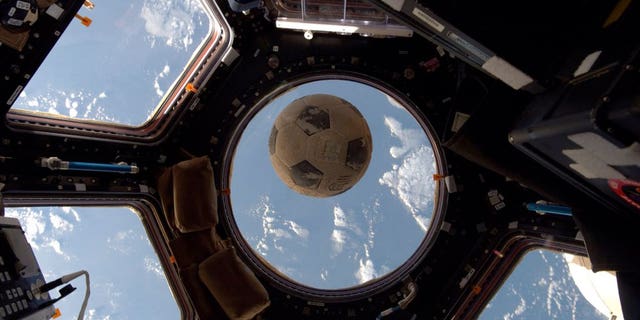 A soccer ball flown aboard the ill-fated launch of the space shuttle Challenger floats on the International Space Station.
