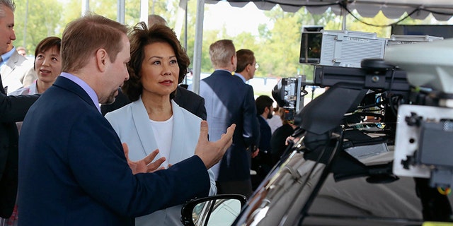 U.S. Transportation Secretary Elaine Chao looks at autonomous vehicle technology after announcing new voluntary safety guidelines for self-driving cars during a visit to an autonomous vehicle testing facility, Tuesday, Sept. 12, 2017, at the University of Michigan, in Ann Arbor, Mich. The new guidelines update policies issued last fall by the Obama administration, which were also largely voluntary. (Hunter Dyke/The Ann Arbor News via AP)