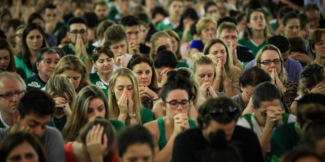 Chapecoense fans attend a mass in Chapeco, Brazil, 29 November 2016. According to reports, 71 people died when an aircraft crashed late 28 November 2016 with 77 people on board, including players of the Brazilian soccer club Chapecoense. Four people registered on the passengers list did not board the plane. The plane crashed in a mountainous area outside Medellin, Colombia as it was approaching the Jose Maria Cordoba airport. The cause of the incident is as yet uknown. Chapecoense were scheduled to play in the Copa Sudamericana final against Medellin's Atletico Nacional on 30 November 2016. (Photo: EPA/Fernando Bizerra Jr.)