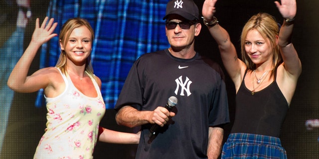 Charlie Sheen (center) on stage with his "Goddesses" Rachel Oberlin , aka Bree Olson (l) and Natalie Kenly (r), onstage during "My Violent Torpedo of Truth/Defeat is Not An Option Show", Radio City Music Hall, New York, 2011.