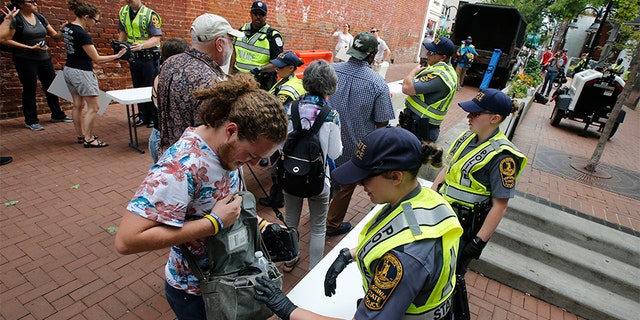 State Police inspect bags on Saturday as they lock down the downtown area.