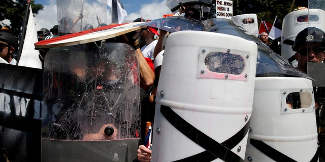 File photo - White nationalists shelter behind shields, displaying the Southern Nationalist flag, after clashing with counter protesters at a rally in Charlottesville, Virginia, U.S., Aug. 12, 2017. (REUTERS/Joshua Roberts)